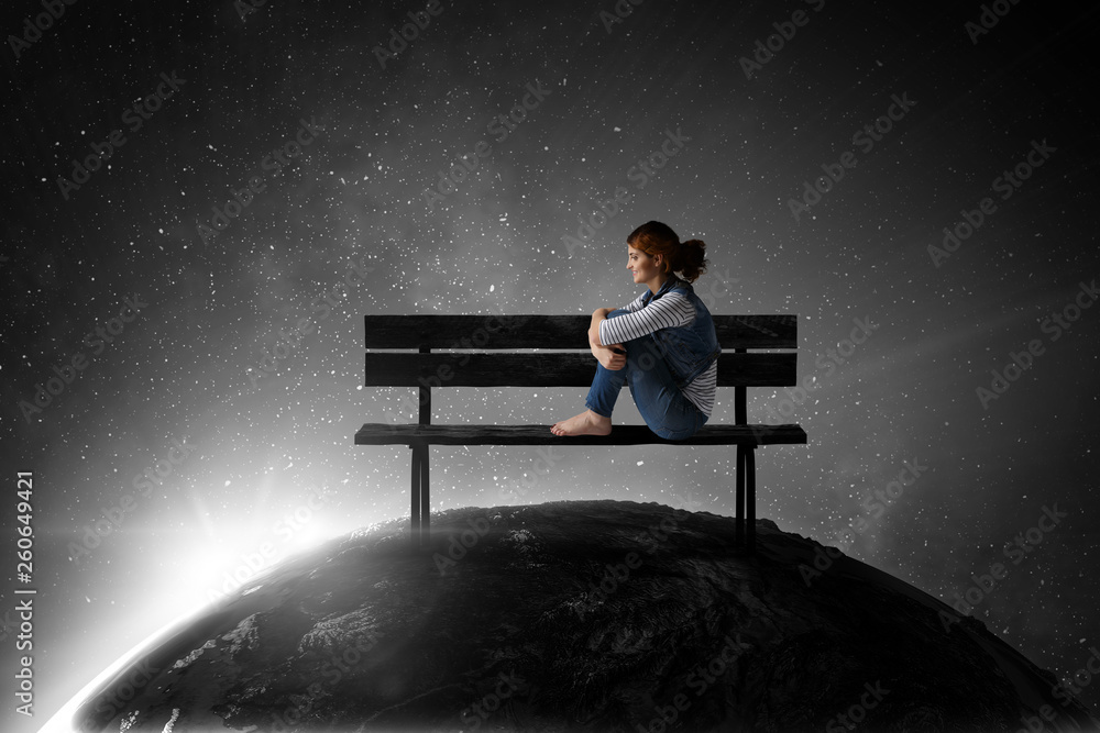 Young woman in casual clothes sitting and hugging knees Young woman in casual clothes sitting and hugging knees