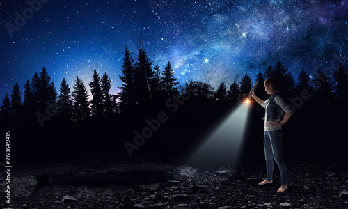 Young woman holding a flashlight