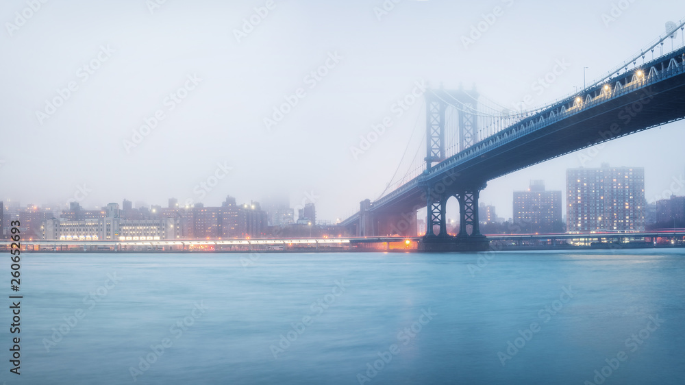 Manhattan bridge and Manhattan at foggy evening, New York City