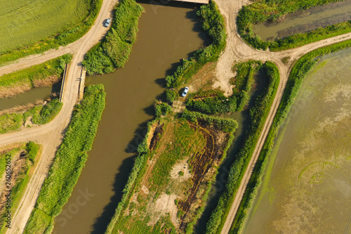 The rice fields are flooded with water. Flooded rice paddies. Agronomic methods of growing rice in the fields. photo