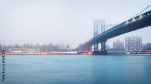Manhattan bridge and Manhattan at foggy evening, New York City