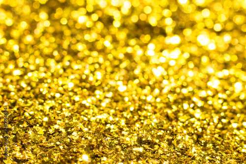 Gold glitter texture. Festive sparkling sequins background. Wpaper for Valentine, New Year or Christmas Holidays.