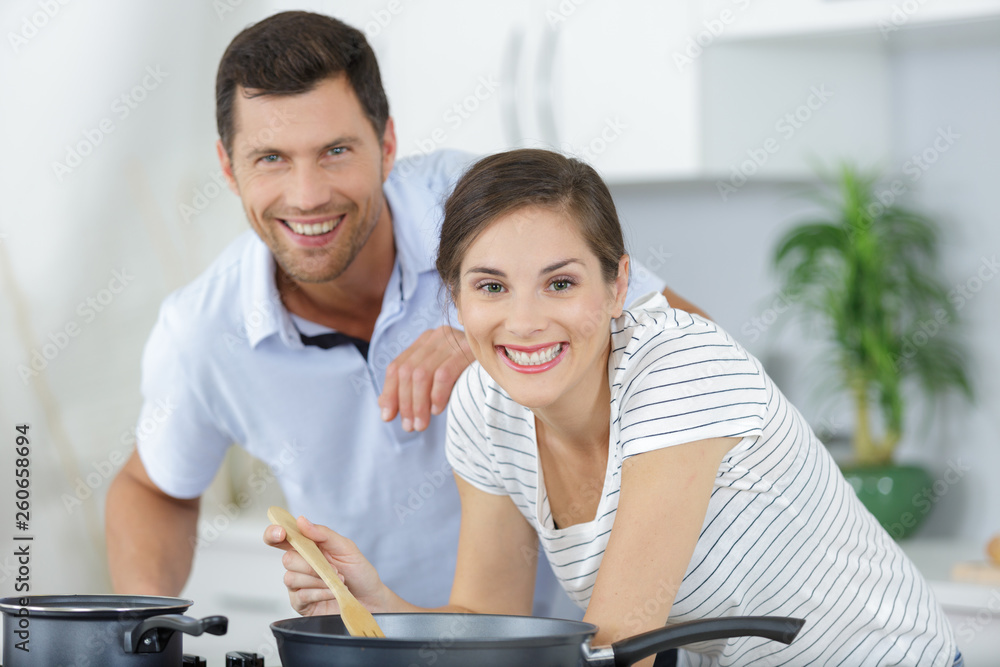 young couple preparing food together young couple preparing food together
