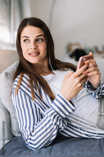 Girl at home listening music. Beautiful young woman listening to music indoors.