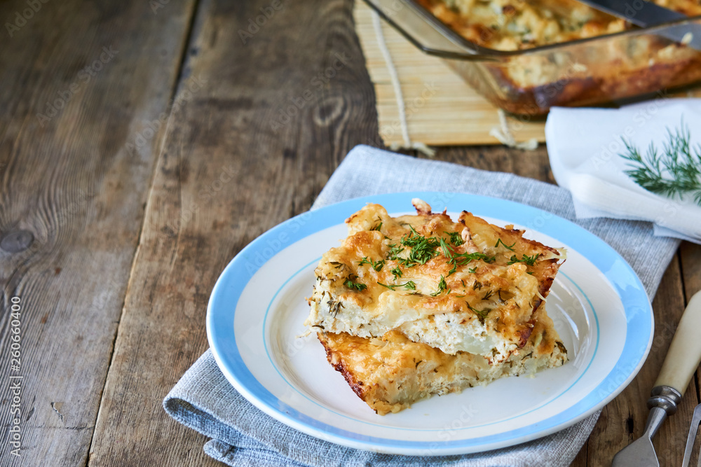 Cauliflower casserole with cheese and fresh herbs 