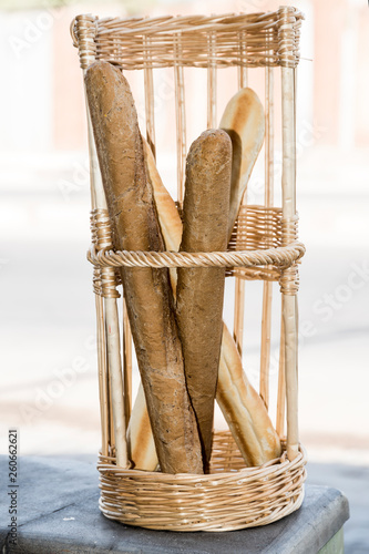 Baguette (french bread sticks) in wooden basket  photo