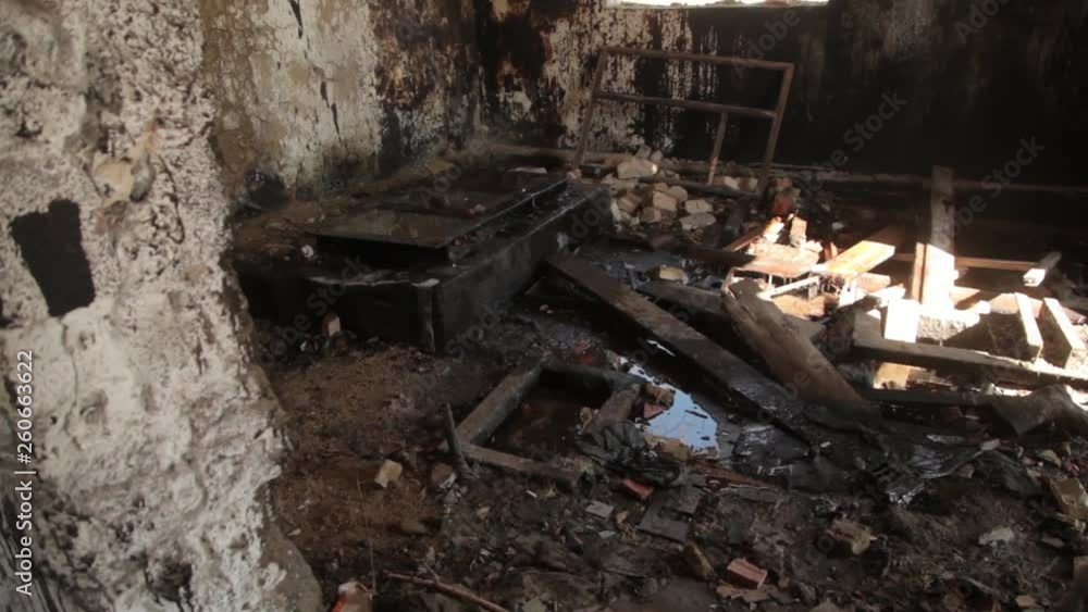 A ruined room with garbage on the floor and holes in the walls. An abandoned house like after the war. A ruined room with garbage on the floor and holes in the walls. An abandoned house like after the war.