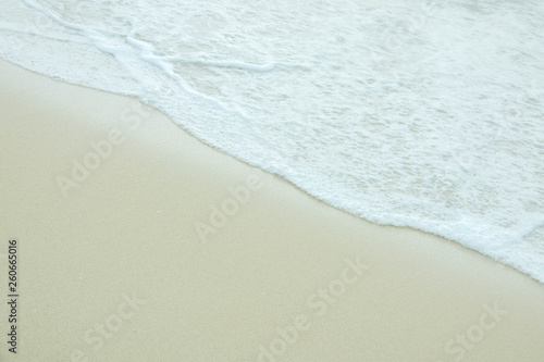 Sea water wave and water foam on beach background