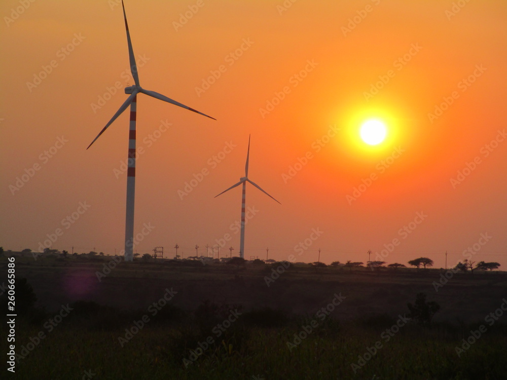 wind turbines at sunset