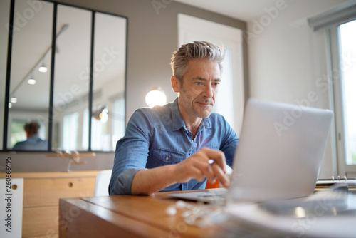 Mature man working from contemporary home