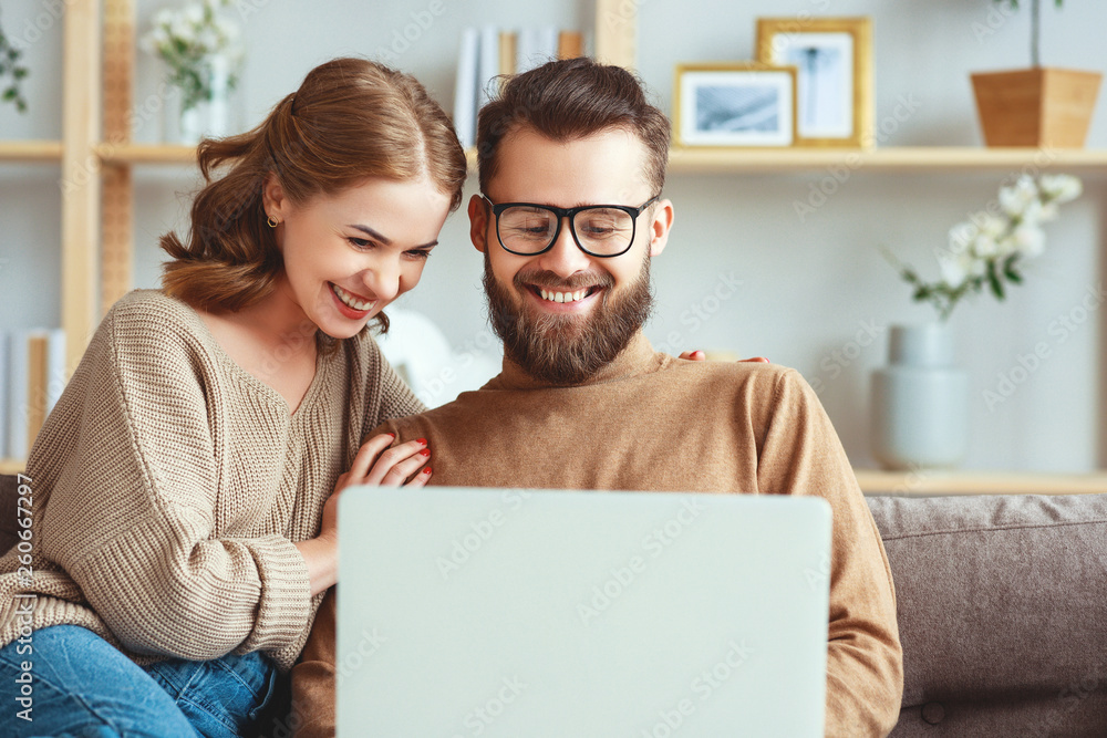 happy couple with laptop computer at home . happy couple with laptop computer at home .