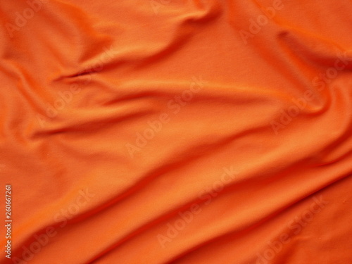 orange sportswear shirt background,silk cloth texture