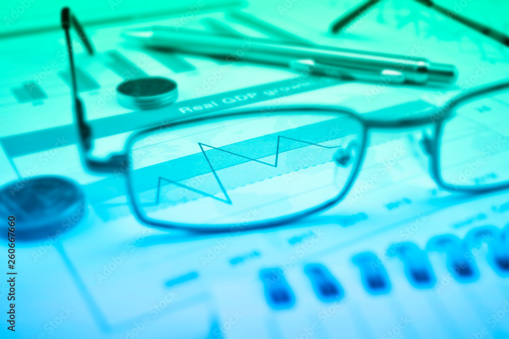 Growth financial graph with eye glasses, coins and pen, Business success concept Growth financial graph with eye glasses, coins and pen, Business success concept