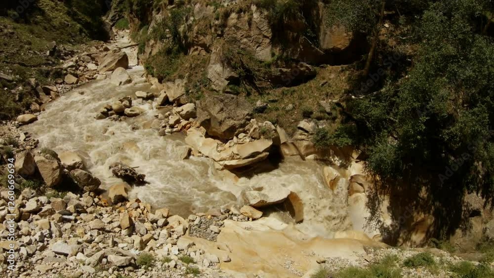 impetuous mountain river tributary of Ganges in stony gorge sunny summer day impetuous mountain river tributary of Ganges in stony gorge sunny summer day