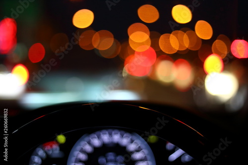 black steering wheel inside car drive in night city street