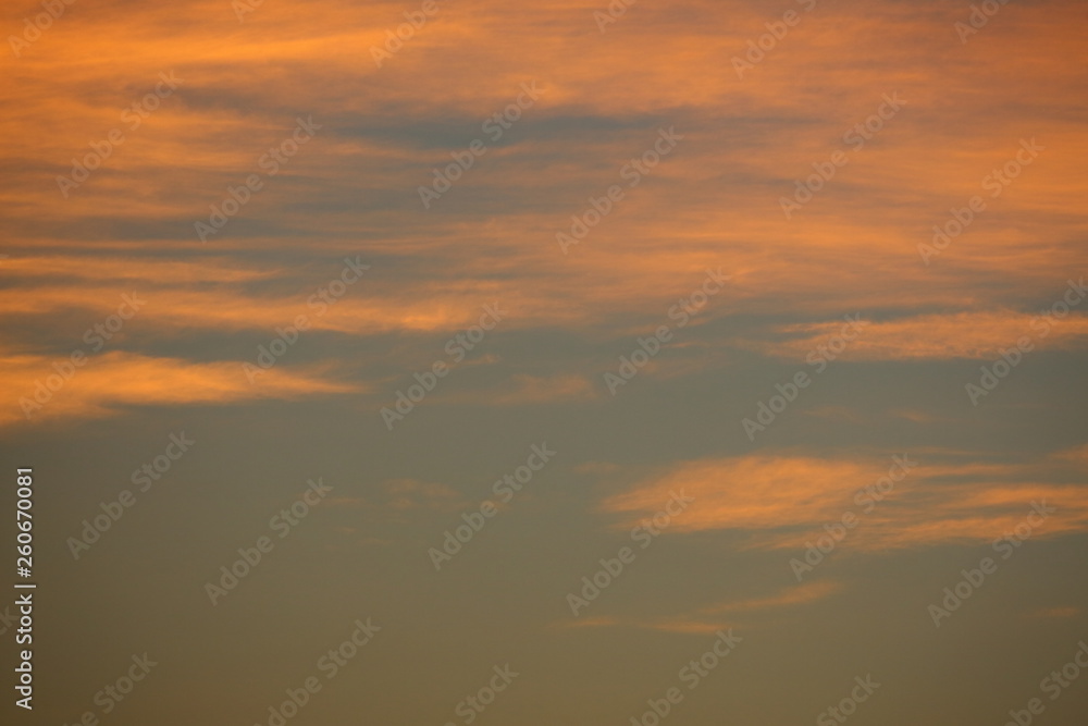 orange sunlight shiny through cloud on dramatic dusk sky