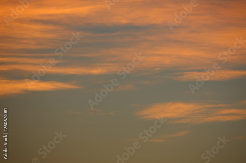 orange sunlight shiny through cloud on dramatic dusk sky © sutichak