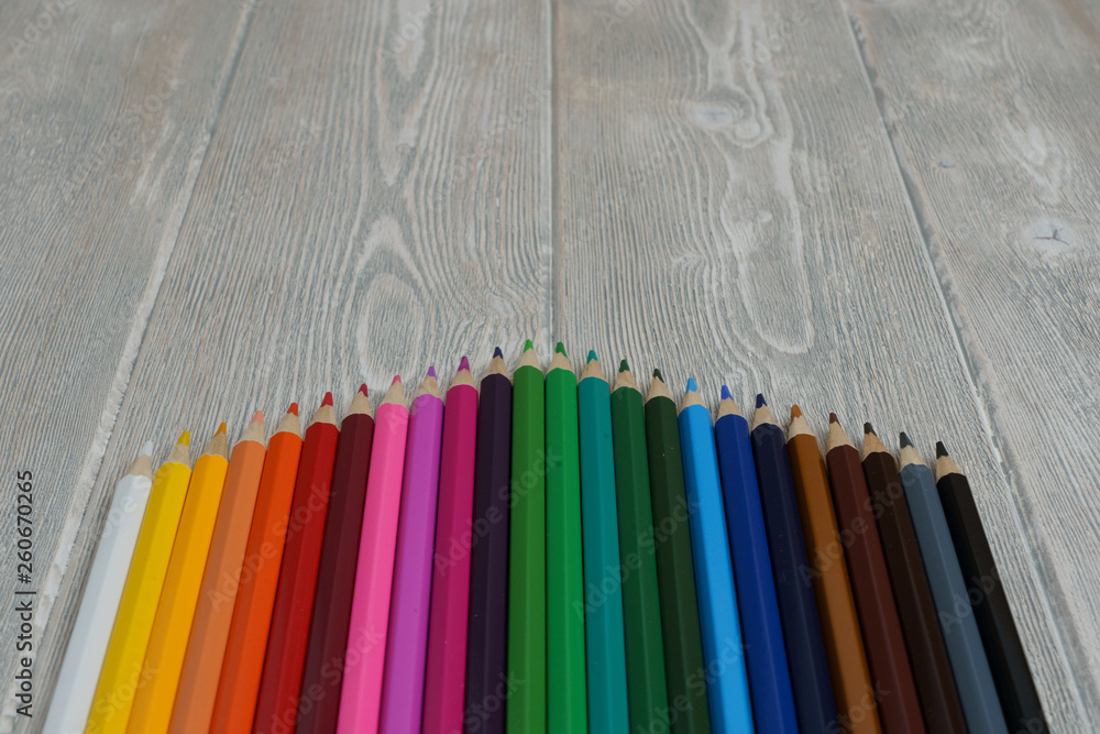 collection of rainbow spectrum color crayons on a white-grey vintage table with copy space collection of rainbow spectrum color crayons on a white-grey vintage table with copy space