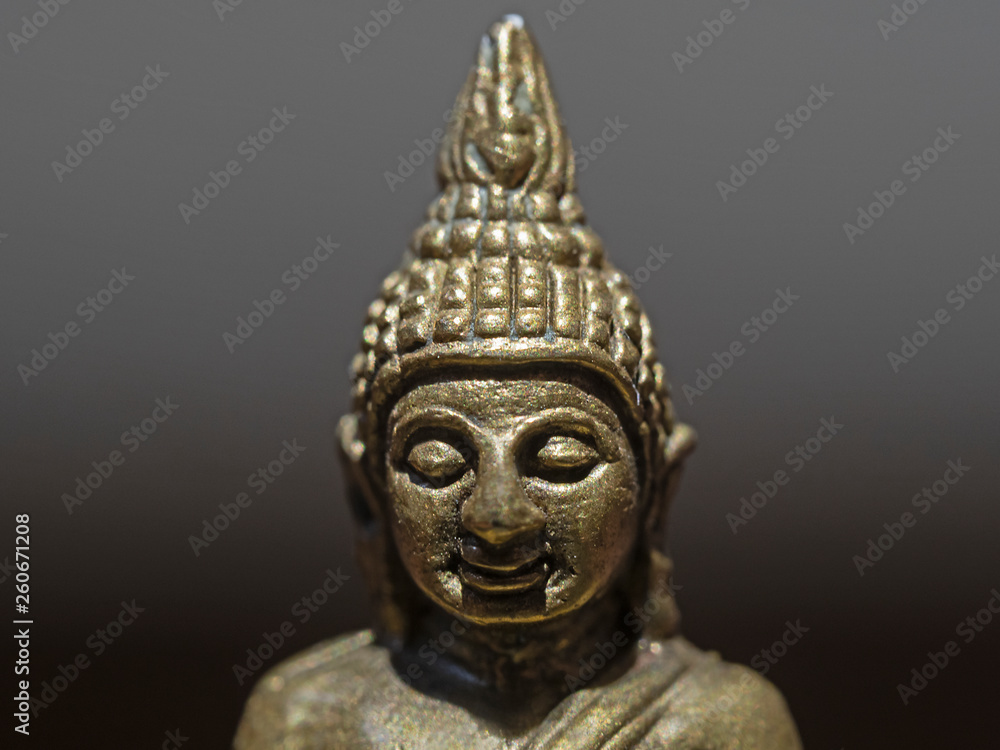 Indoor close-up photography of a bronce buddha statue.