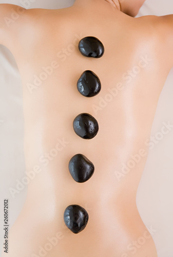 Stones on Woman's Back, Woman Having LaStone Therapy (Healing Therapy Using Stones).
