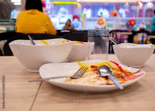Dirty dishes on the table after lunch at food court in the mall. Dish ready for washing.