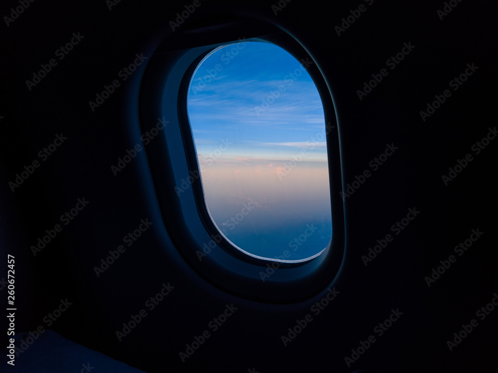 Blue sky view through the airplane window. Blue sky view through the airplane window.