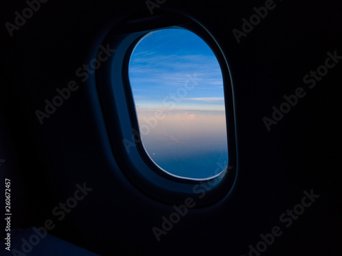 Blue sky view through the airplane window.