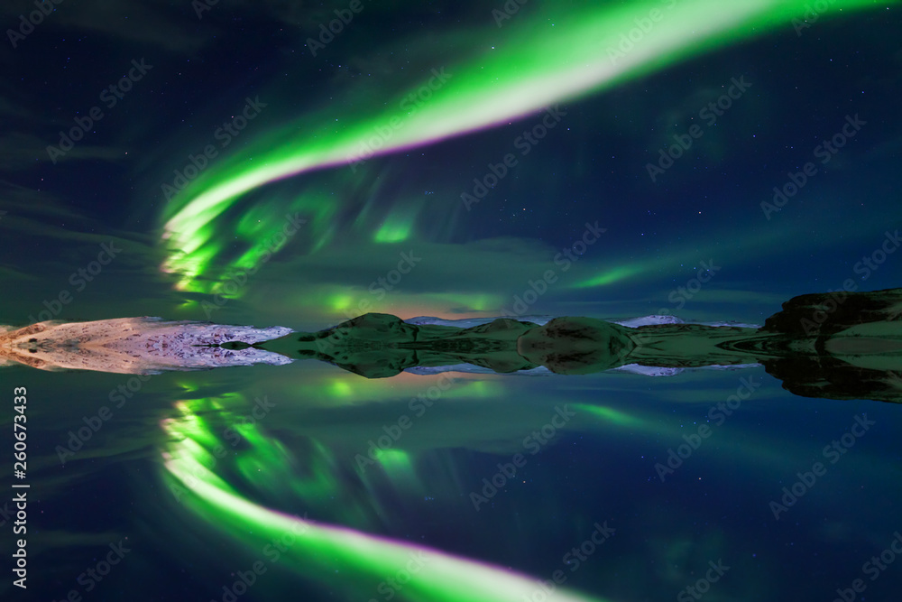 Reflection of the northern lights in the water, Aurora Borealis, Iceland.