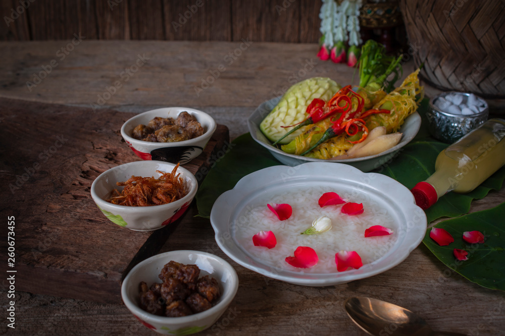 Khao-Chae, Cooked Rice Soaked in Iced Water in the white bowl and Eaten with the Usual Complementary Food and to decorate by flower, scented water.
