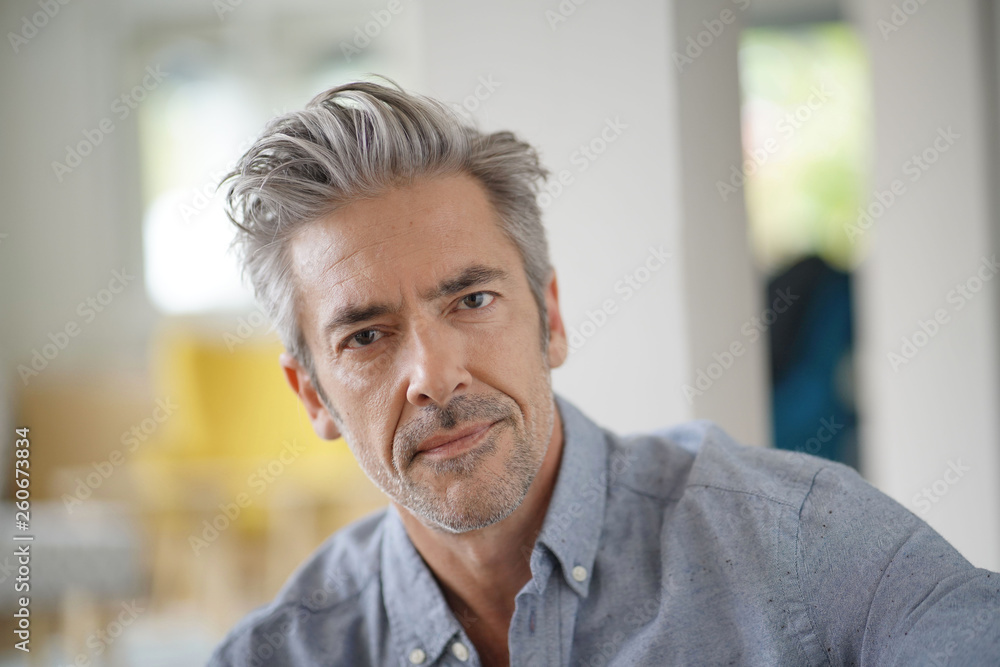 Portrait of handsome mature man looking at camera in contemporary home Portrait of handsome mature man looking at camera in contemporary home