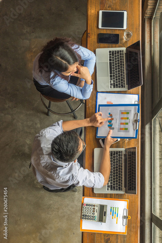 Asian office worker discuss about financial number on report