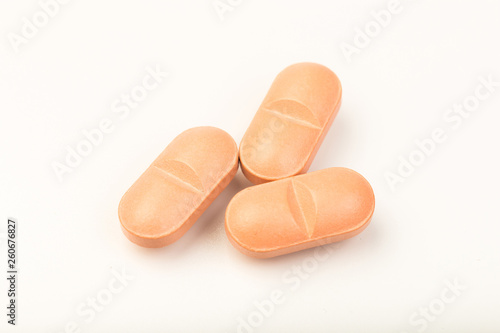 pink  pills close up on white background