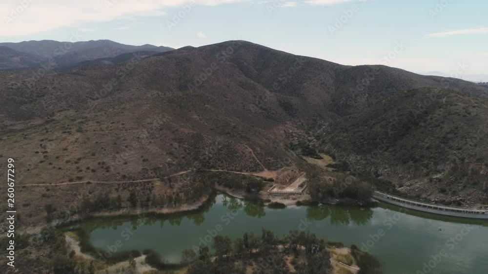 AERIAL: Drone Zoom in of Mountain by Green Water Lake (Otay Lake) AERIAL: Drone Zoom in of Mountain by Green Water Lake (Otay Lake)