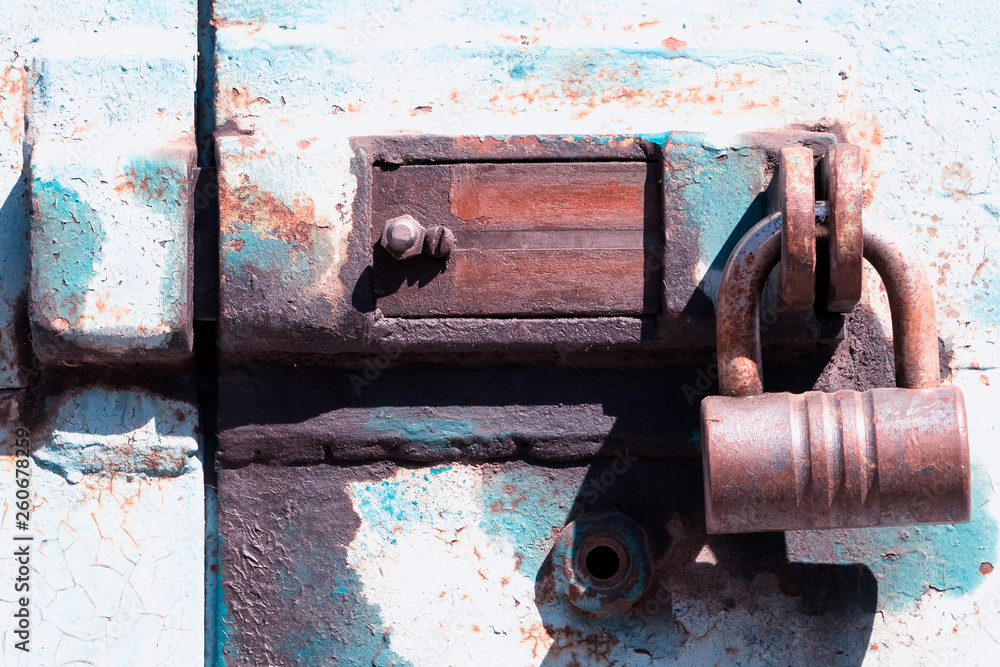 Old deadbolt with padlock.