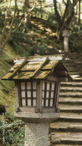 Stone lantern in front of a set of stairs in a temple in Kyoto, Japan © schistra