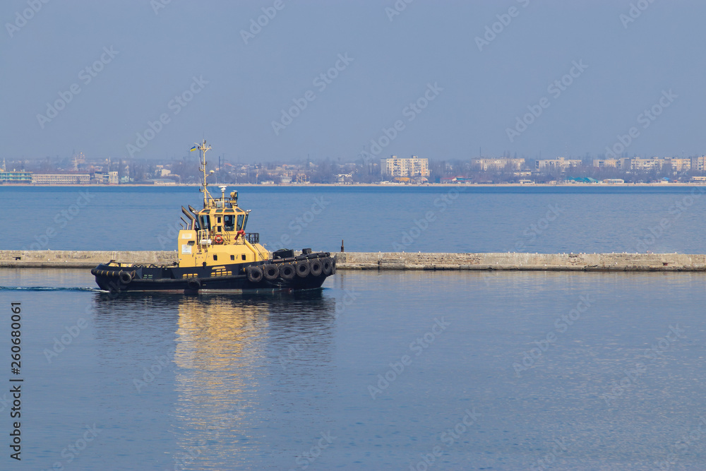 tugboat sailing on sea water against the sky. Sea port of Odessa, Ukraine