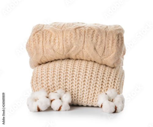 Cotton flowers with knitted sweaters on white background
