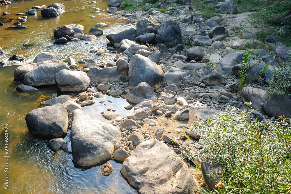 Rocks in various sizes in a river water stream in natural park Rocks in various sizes in a river water stream in natural park