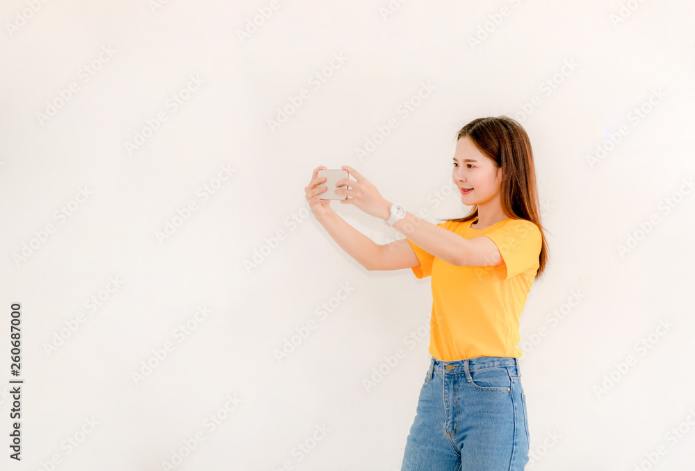 Asian women holding phones while selfies Asian women with smiling faces, smiling selfies on a white background Women taking selfies Asian women holding phones while selfies Asian women with smiling faces, smiling selfies on a white background Women taking selfies