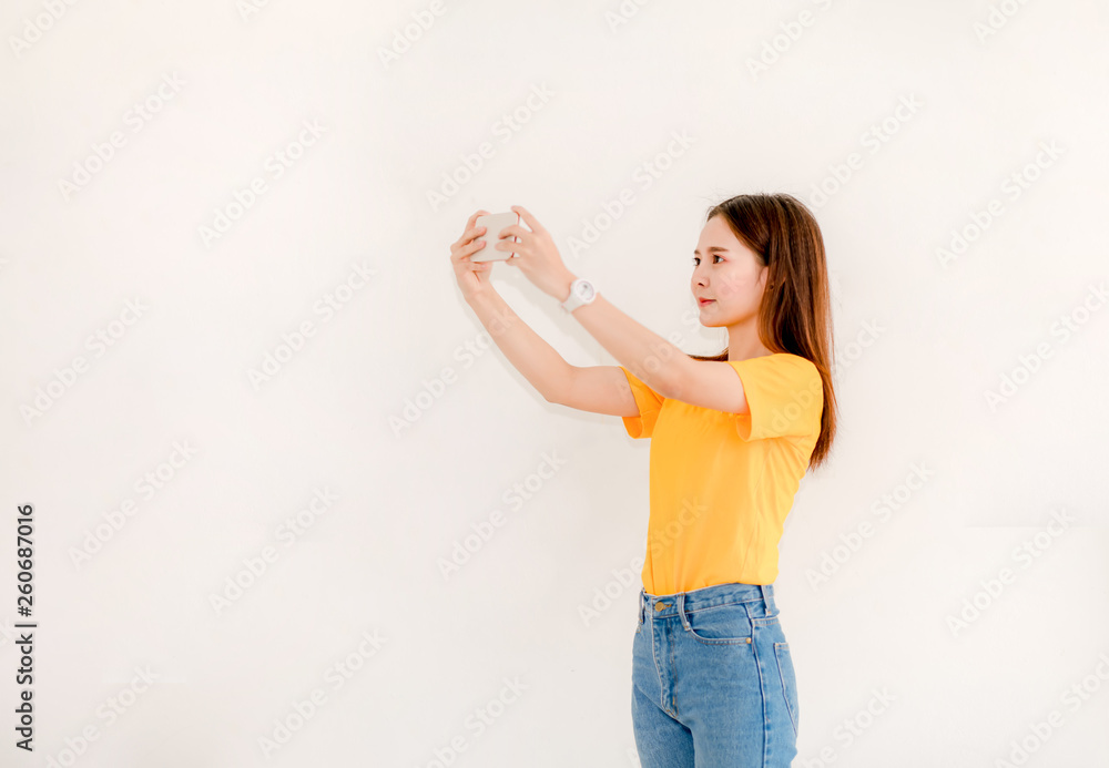 Asian women holding phones while selfies Asian women with smiling faces, smiling selfies on a white background Women taking selfies Asian women holding phones while selfies Asian women with smiling faces, smiling selfies on a white background Women taking selfies