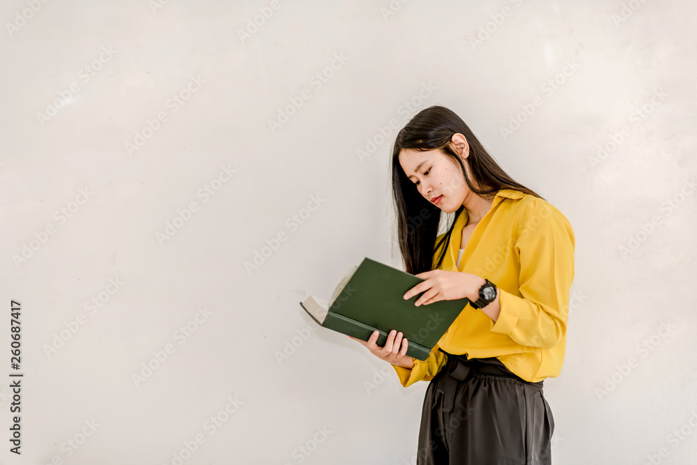 Obraz premium Asian girl holding a book with copy space