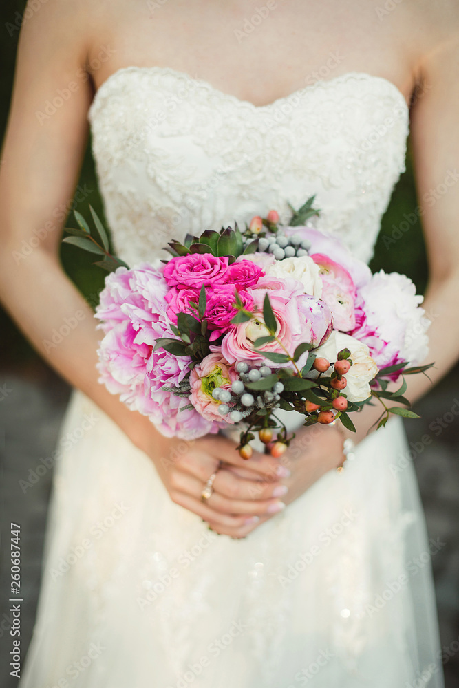 Beautiful wedding bouquet in the hands of the bride. Beautiful wedding bouquet in the hands of the bride.