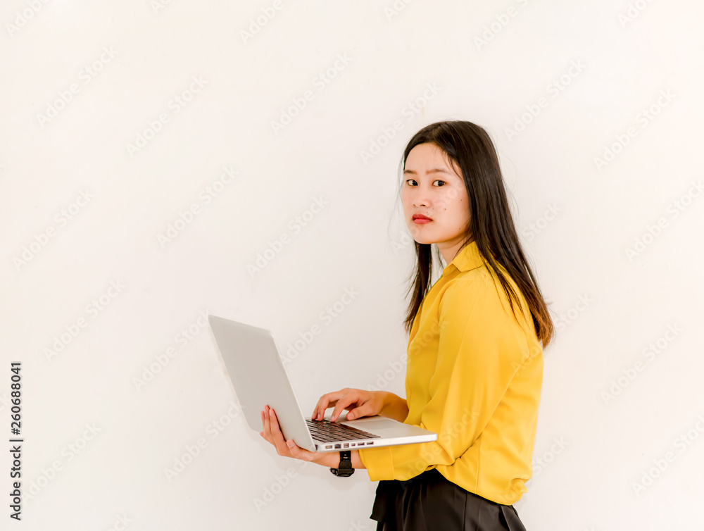 Smile Asian girl holding a laptop computer separately on a white background. Smile Asian girl holding a laptop computer separately on a white background.