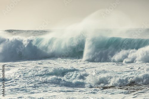 Big ocean waves at sunset.