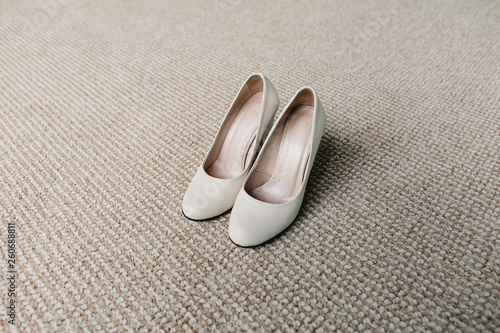 Shoes in white on a beige background.