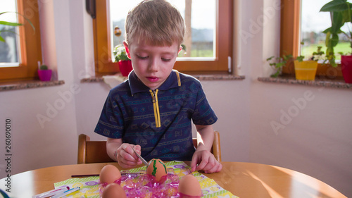Child make Easter eggs