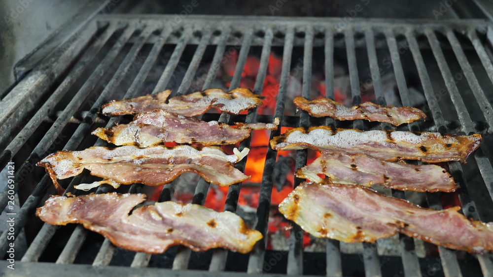 Eight slices of bacon are grilled in the restaurant's kitchen, ingredients for burgers salads