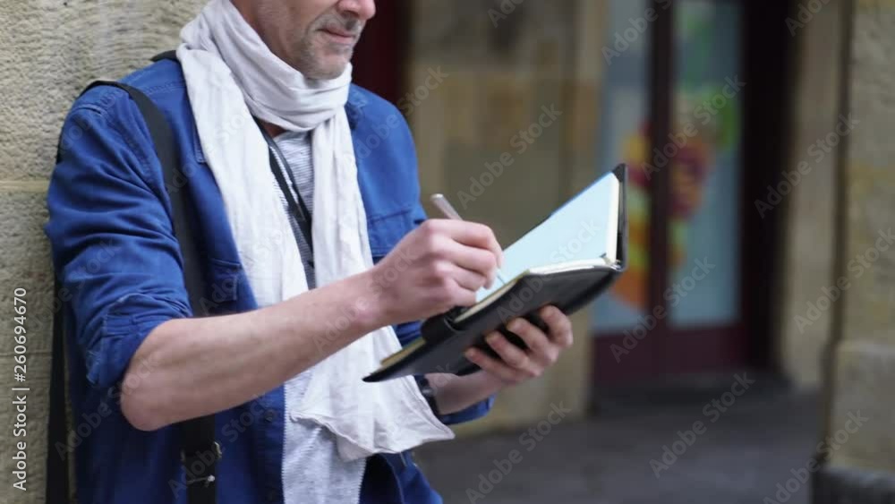 Mature artist sketching in beautiful historical town Mature artist sketching in beautiful historical town