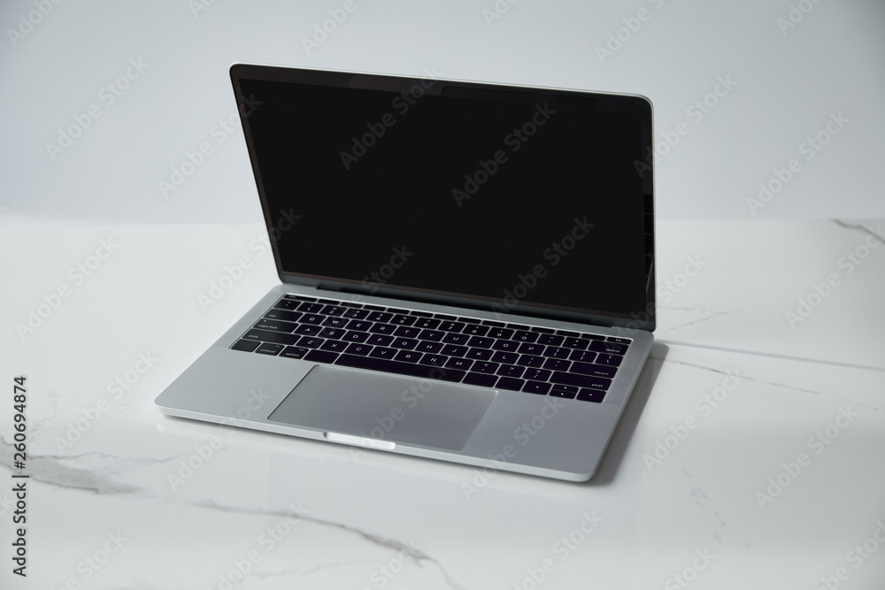 laptop with blank screen and black keyboard on white marble surface isolated on grey laptop with blank screen and black keyboard on white marble surface isolated on grey