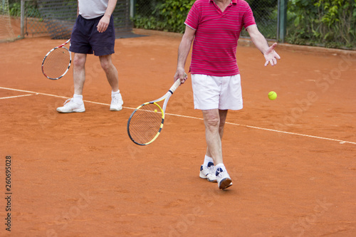 Doubles tennis player with partner in the background © smuki